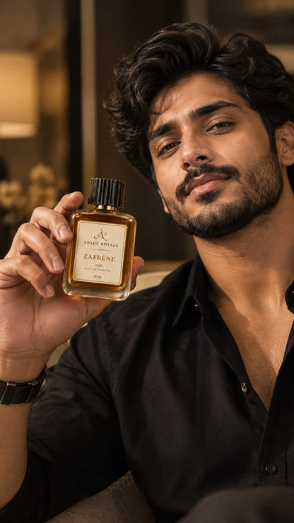 Man in a black shirt holding Arshè Royale Zafrène Oud Eau de Parfum bottle
